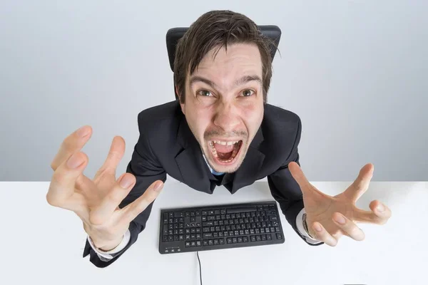 Angry and frustrated man is working with computer and shouting. — Stock Photo, Image