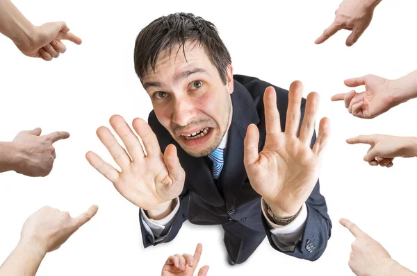 Many hands are pointing and blame stressed man. Isolated on whit — Stock Photo, Image