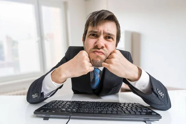 El joven trabaja con la computadora y te mira. . — Foto de Stock