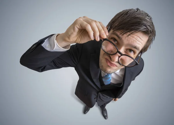 Young suspicious man is looking at you. View from top. — Stock Photo, Image