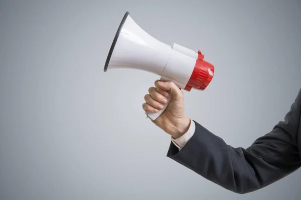 Announcement concept. Hand holds megaphone. — Stock Photo, Image