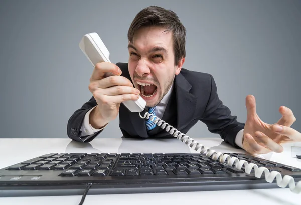 Angry boss or manager is calling and shouting to the telephone. — Stock Photo, Image