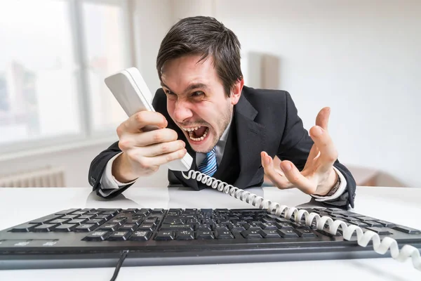 Angry boss or manager is calling and shouting to the telephone. — Stock Photo, Image