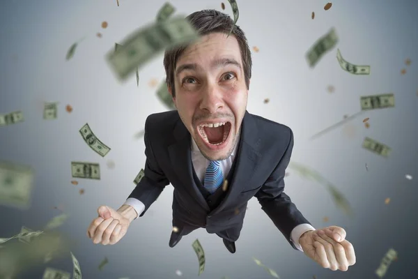 Young successful businessman is a winner. Money are falling from — Stock Photo, Image