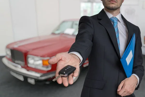 Vendedor está vendiendo un coche nuevo y pasando llaves . — Foto de Stock