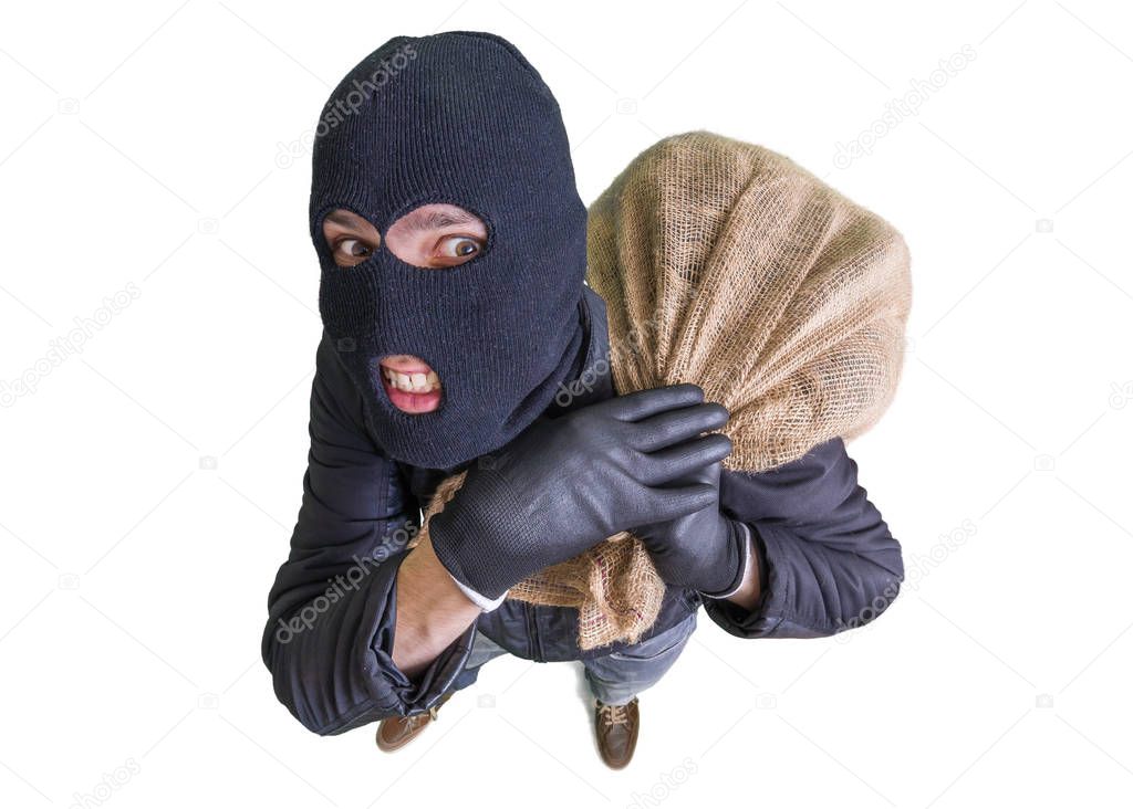 Thief or burglar is carrying bag full of money. View from above.