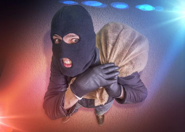 Thief or burglar carrying bag full of money is arrested. Police — Stock Photo, Image