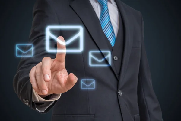 Businessman is touching mail symbol with finger on futuristic sc — Stock Photo, Image