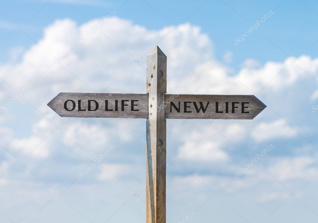 Road sign with old life and new life direction against sky.