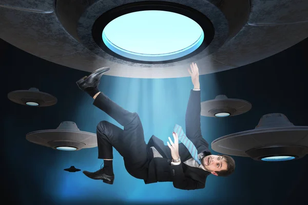 Alien abduction concept. Young man is abducted by UFO. — Stock Photo, Image
