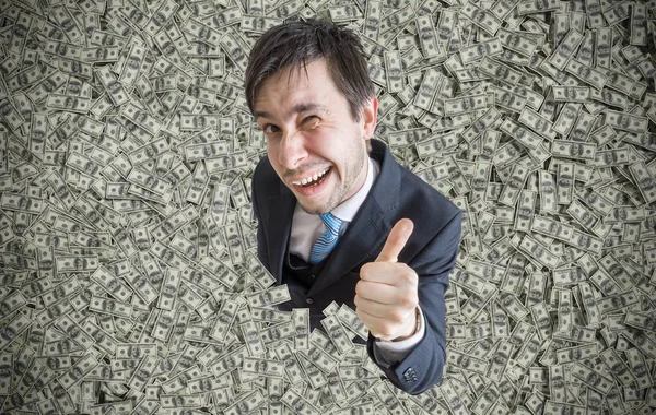 Successful millionaire covered with money is showing thumbs up g — Stock Photo, Image