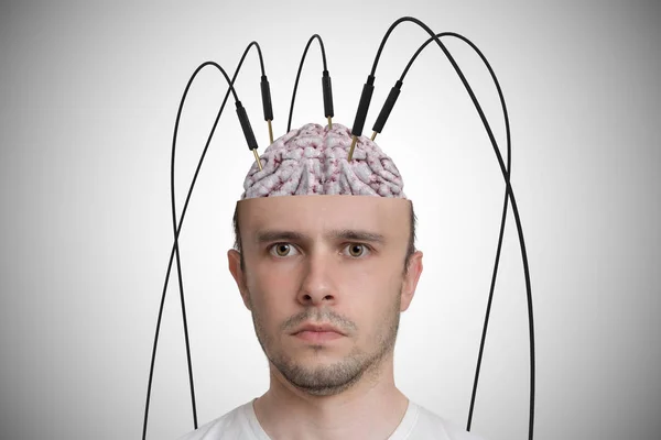 Neuroscience and brain research concept. Young man has cables an — Stock Photo, Image