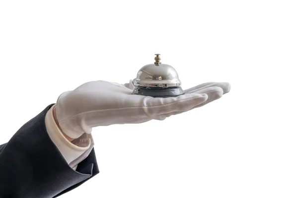 Ręka w białych rękawiczkach trzyma usługi dzwon. Na białym tle na b biały — Zdjęcie stockowe