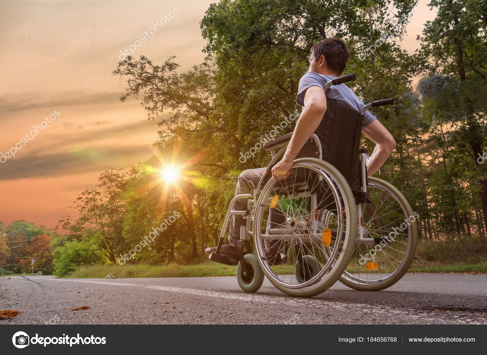 Disabled or young man wheelchair nature at sun Stock Photo by ©vchalup2