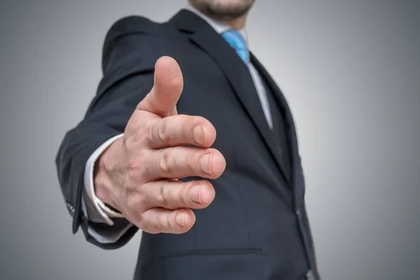 Businessman is offering hand for handshake. Invitation and deal — Stock Photo, Image