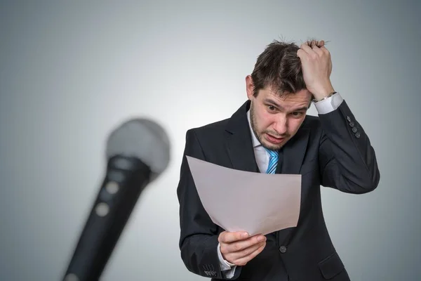 Nervous man is afraid of public speech and sweating. Microphone — Stock Photo, Image