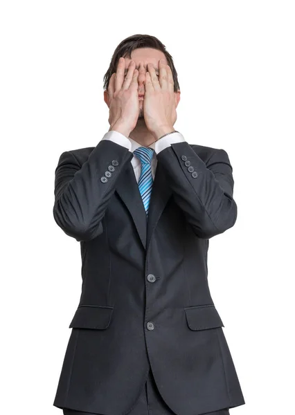 Disappointed man is covering his face with hands. Isolated on wh — Stock Photo, Image