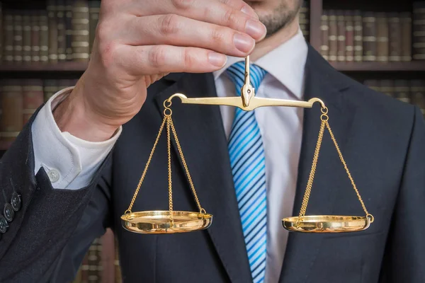 Law and justice concept. Lawyer is holding justice scales in han — Stock Photo, Image