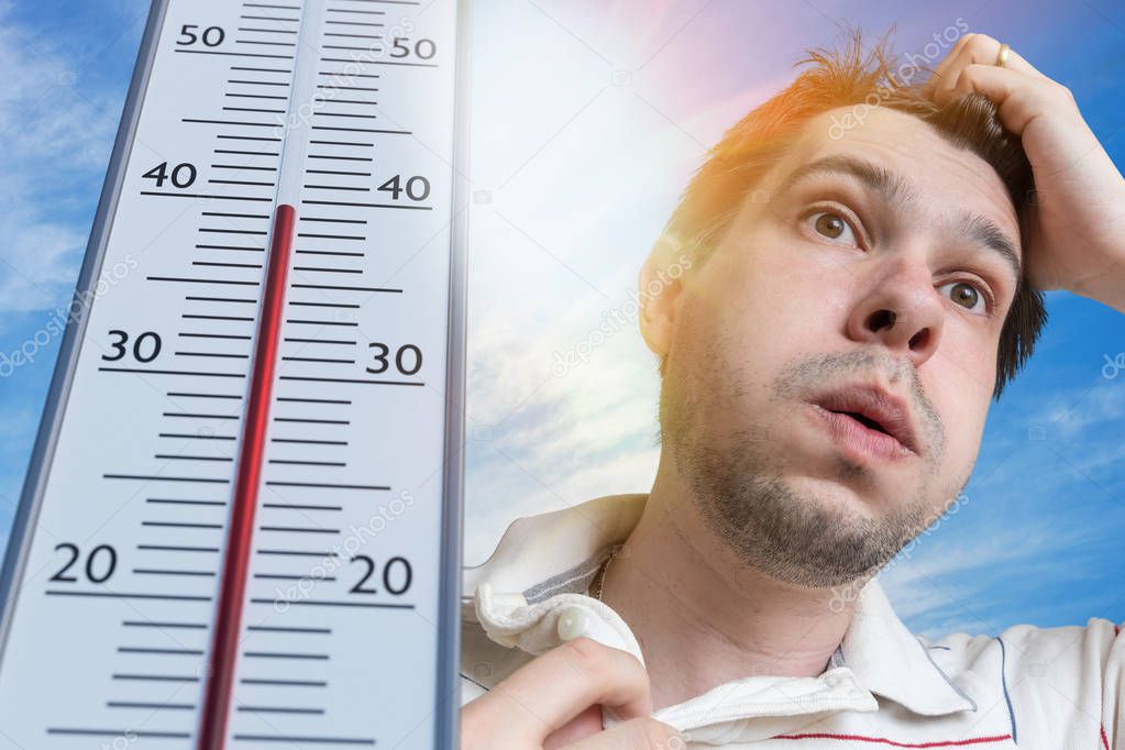 Hot weather concept. Young man is sweating. Thermometer is showing high temperature. Sun in background.