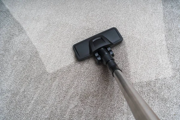 Vacuum cleaner is cleaning dirty carpet. Housework concept. — Stock Photo, Image