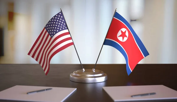 USA and North Korean flags on table. Negotiation between North K