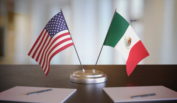 USA and Mexican flags on table. Negotiation between Mexico and U