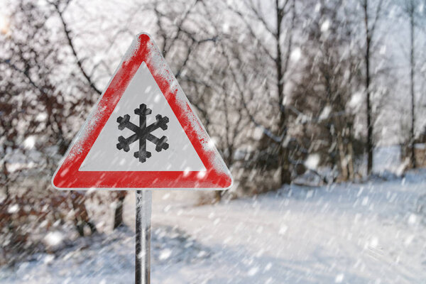 Warning road sign before ice break. Snowy road ad winter.