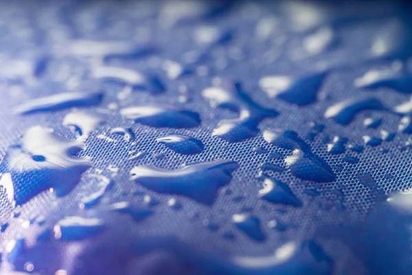 Vista Cerca Gotas Agua Sobre Textil Impregnado Impermeable Azul — Foto de Stock