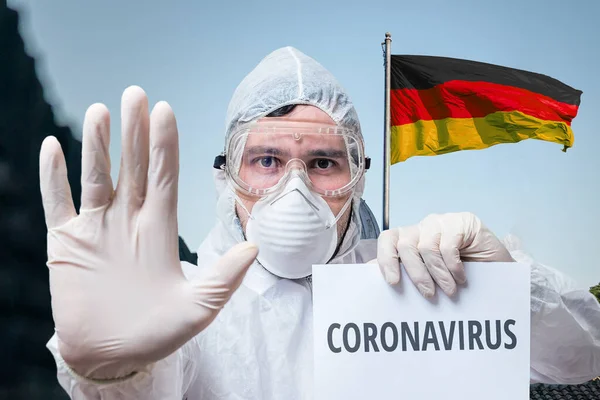 Doctor Coveralls Warns Coronavirus Infection Germany German Flag Background — Stock Photo, Image