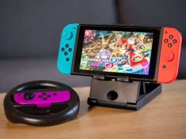 UK - Feb 2020: Nintendo Switch games console with Mario Kart and wheel controller