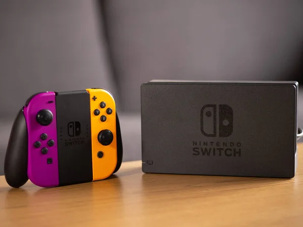 UK - Feb 2020: Nintendo Switch purple and orange joy con controller and portable console — Zdjęcie stockowe