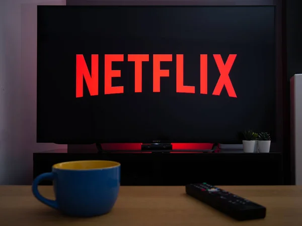 stock image UK, March 2020: TV Television Netflix logo streaming service in dark home