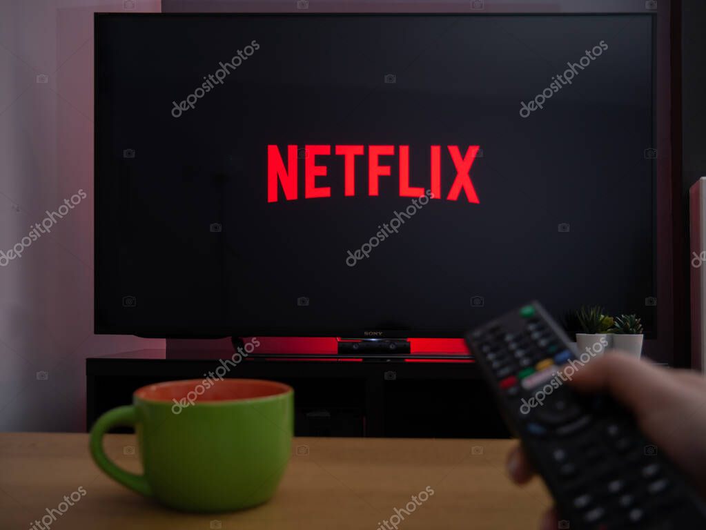 UK, March 2020: TV Television Netflix logo on screen with remote
