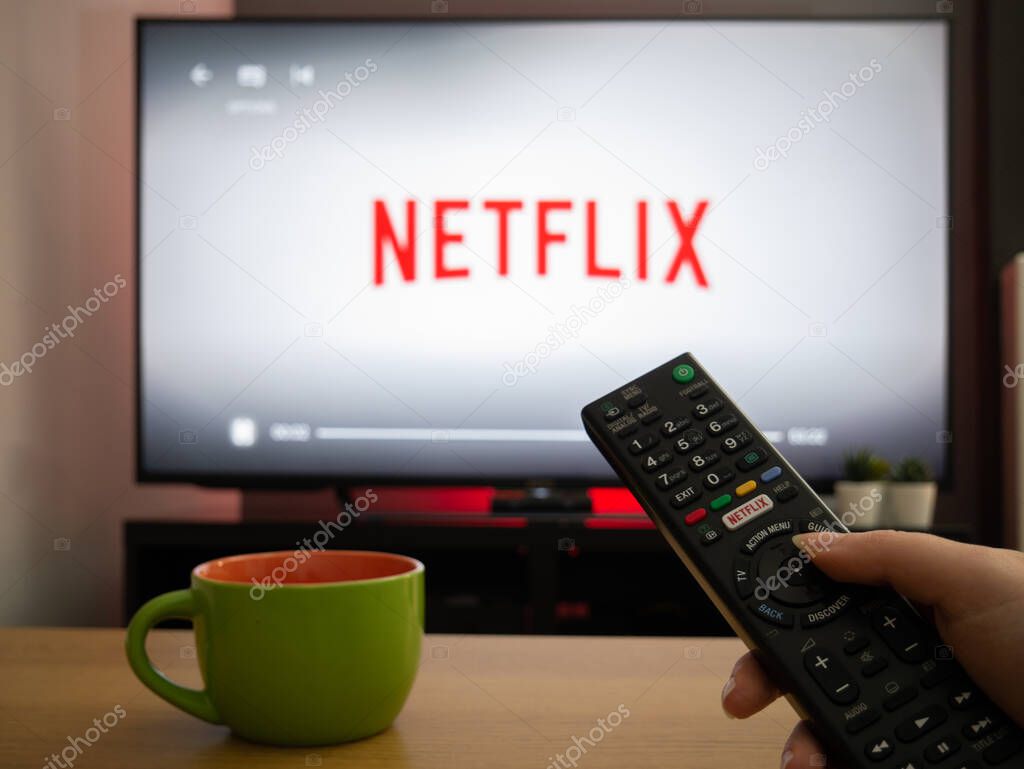 UK, March 2020: TV Television white netflix background with remote control