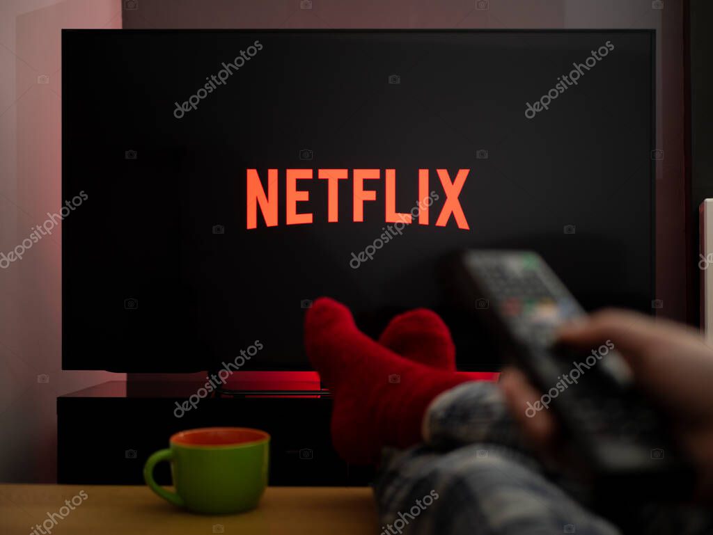 UK, March 2020: TV Television feet up watching Netflix on tv