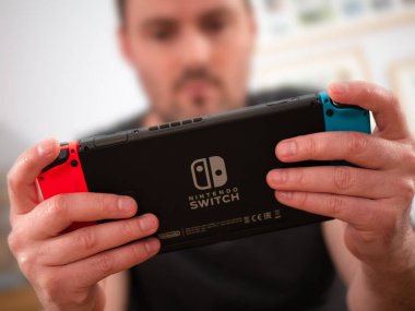 İngiltere, Mart 2020: Nintendo Elde tutulan yetişkin oyuncu logolu oyun konsolu