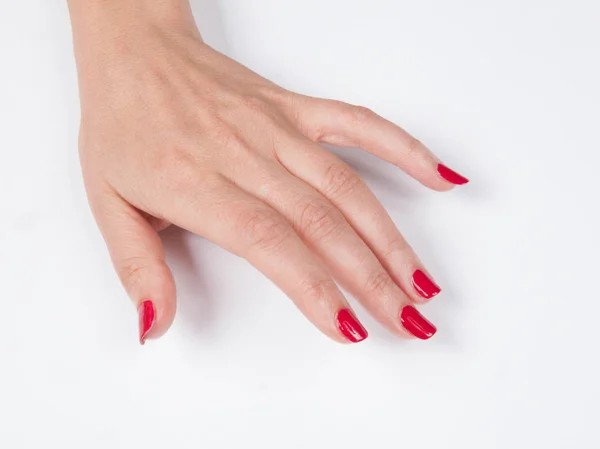 Mano de mujer con manicura roja — Foto de Stock