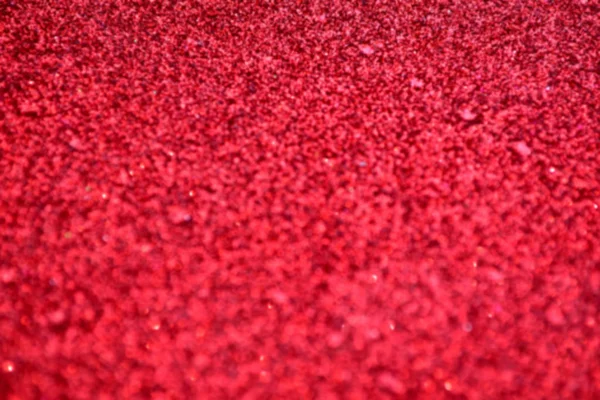 明るい、抽象的なぼやけた赤の背景にきらめくグリッターします。 — ストック写真