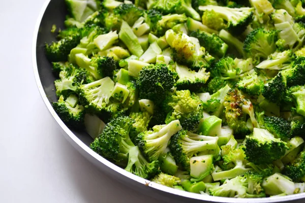 Roasted and cut fresh healthy broccoli cabbage in a pan on white background — Stock Photo, Image