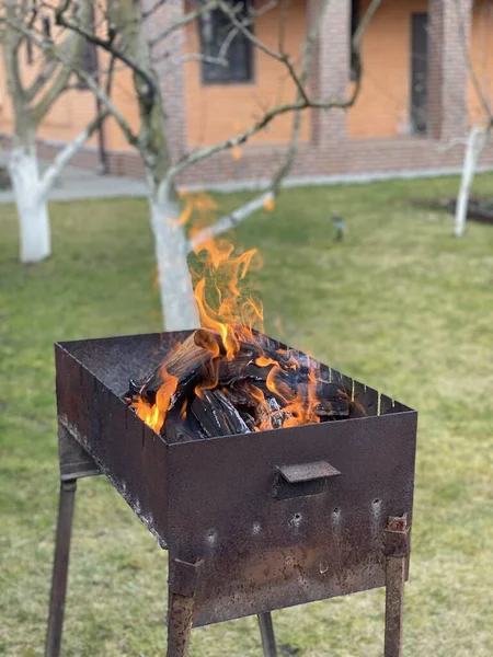 Empty barbecue grid with fire at the house backyard picnic