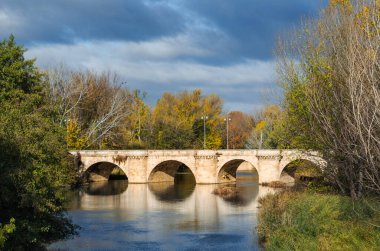 medieval stone bridge, puente mayor, crossing carrion river, palencia, spain
