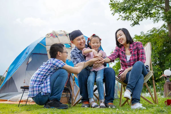 Happy Asian family camping on vacation