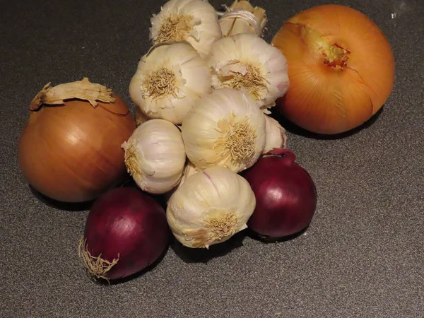 Garlic and onions on grey — Stock Photo, Image