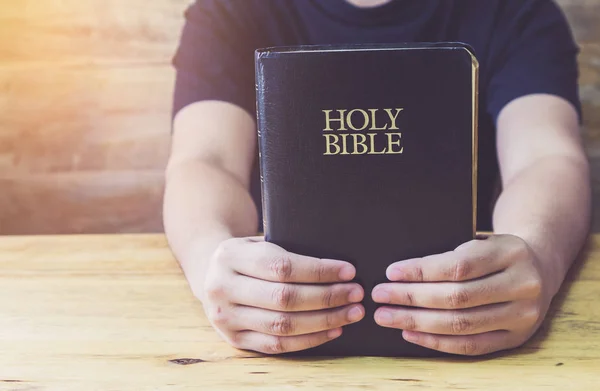 Primer Plano Una Mano Hombre Sosteniendo Sagrada Biblia Sobre Una — Foto de Stock