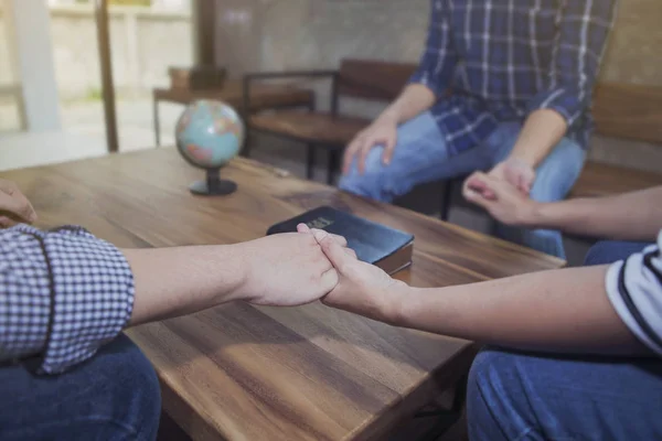 Christian Friends Holding Hands Together Surrounded Wooden Table Blurred Bible — Stock Photo, Image