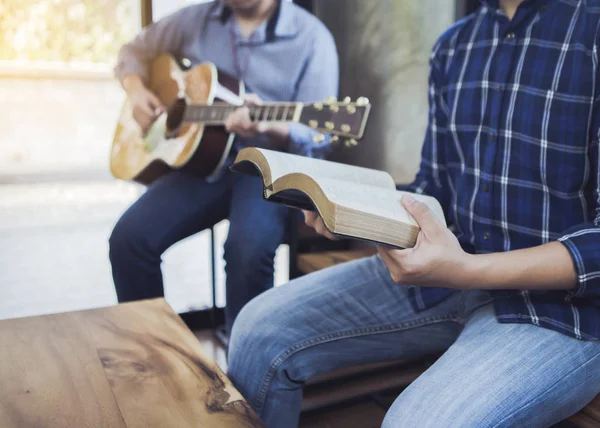 Чоловік Співає Пісню Гімнової Книги Його Друзі Грають Гітарі Приміщенні — стокове фото