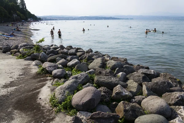 Personas tomando el sol en la playa el 30 de julio de 2016 en Desenzano del Garda, Italia . — Foto de Stock