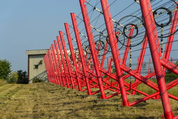 Communication wires lead to switching station from radio transmitter tower — Stock Photo, Image