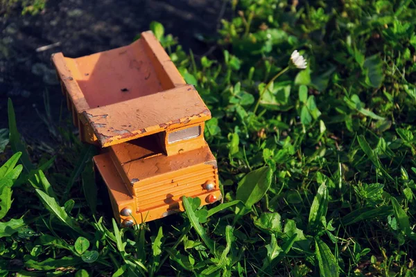 Filtered vintage orange car toy truck on green grass — Stock Photo, Image