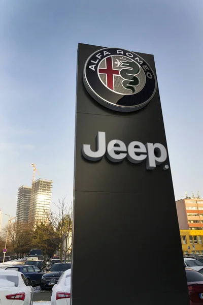 Jeep and Alfa Romeo car logo on dealership building on January 20, 2017 in Prague, Czech republic. American regulator EPA investigate Fiat Chrysler Automobiles for emissions cheating. — Stock Photo, Image